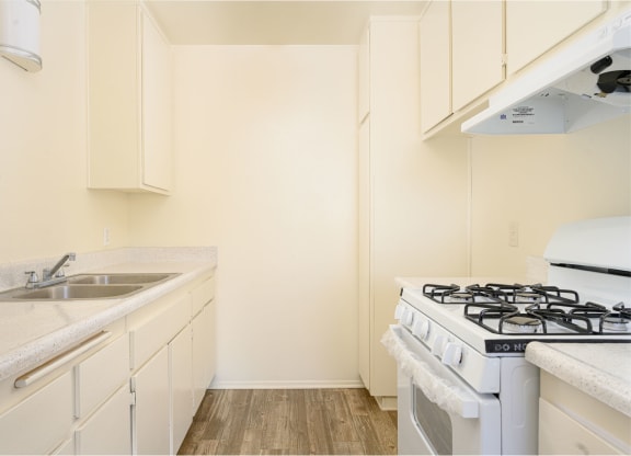 a kitchen with white cabinets and a white stove top oven at Villa Hemet, Hemet, CA 92543