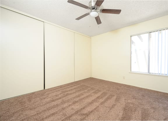a bedroom with white walls and a ceiling fan at Villa Hemet, Hemet, 92543
