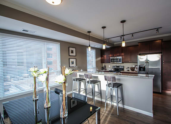 a kitchen and dining area  at Victoria Park and V2 Apartments, St. Paul, MN