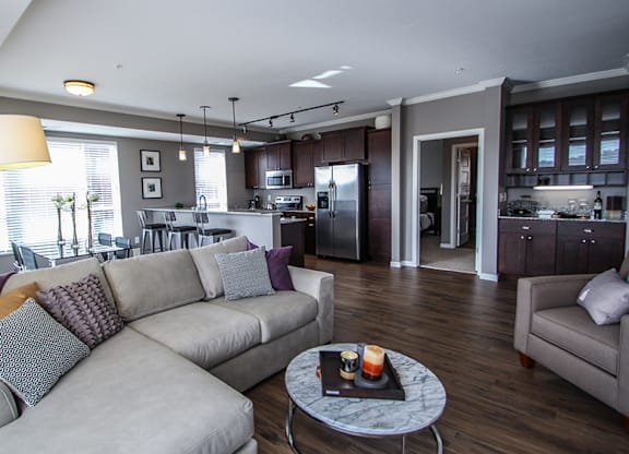 a living room with a couch and a table  at Victoria Park and V2 Apartments, Minnesota, 55102