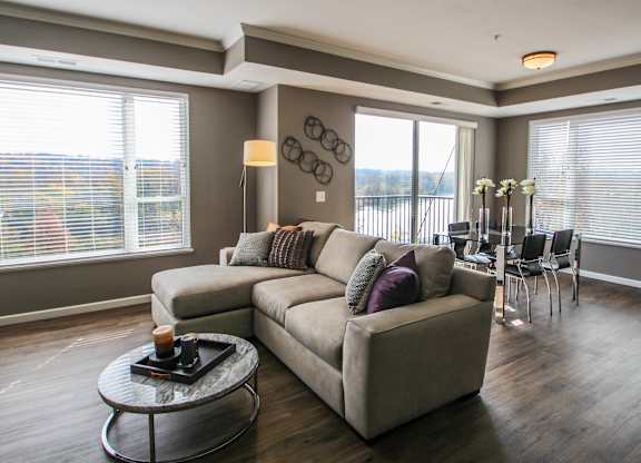 a living room with a couch and a table  at Victoria Park and V2 Apartments, Minnesota, 55102