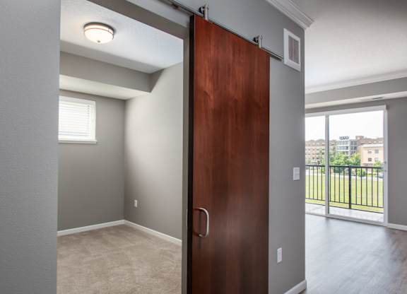 a bedroom with a sliding door  at Victoria Park and V2 Apartments, St. Paul