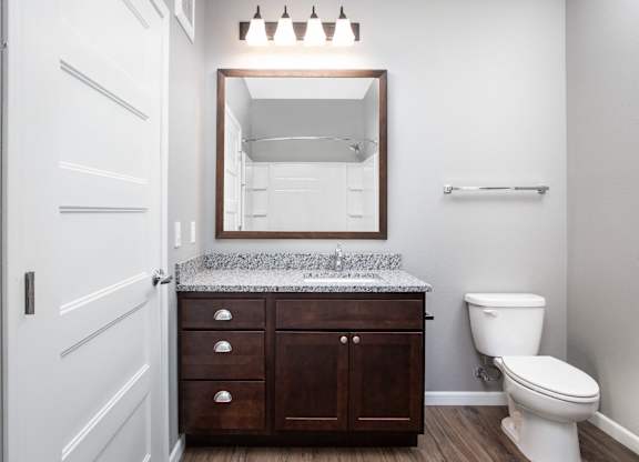 a bathroom with a toilet and a sink  at Victoria Park and V2 Apartments, St. Paul