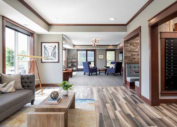 a common area filled with furniture and a large window  at Victoria Park and V2 Apartments, St. Paul