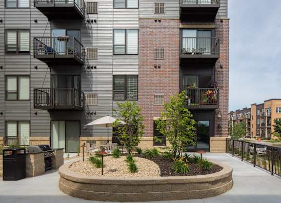 an outdoor courtyard with trees and plants  at Victoria Park and V2 Apartments, St. Paul