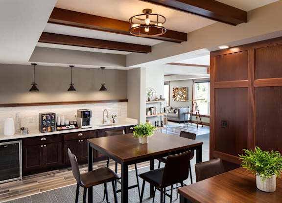 a view of the community room with a coffee bar  at Victoria Park and V2 Apartments, St. Paul