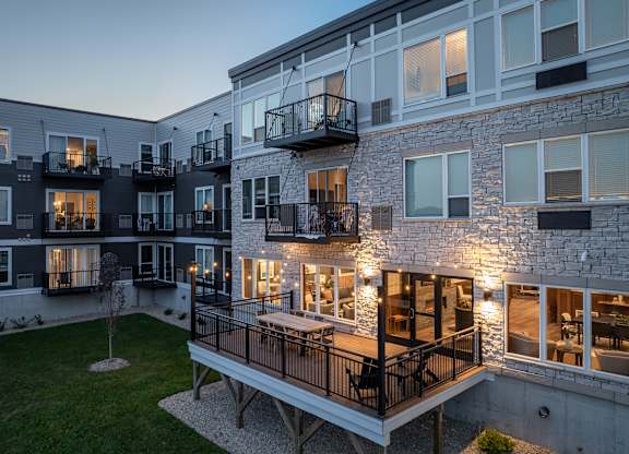 A modern apartment building with balconies and a courtyard.