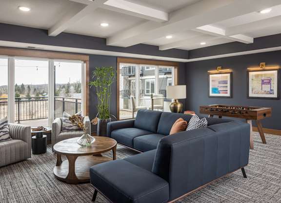 A living room with a blue couch and a coffee table.