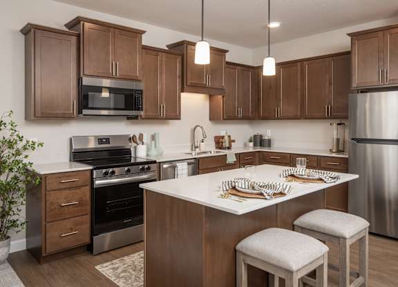 A kitchen with wooden cabinets and stainless steel appliances.