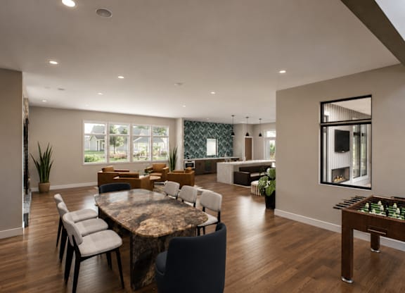 A modern dining room with a large table and chairs.