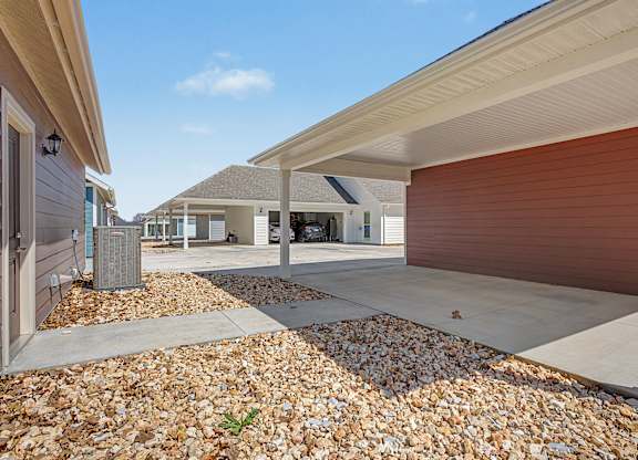 A row of houses with a gravel area in the foreground.