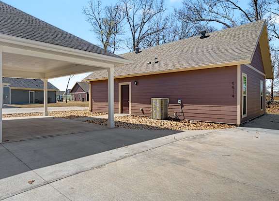 A house with a covered porch and a brown garage door.