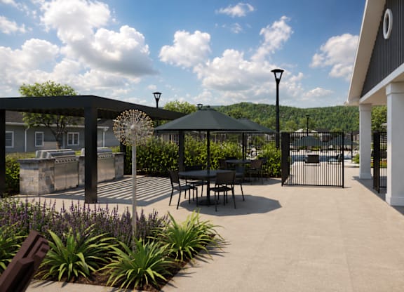 A patio area with a table and chairs under a gazebo.