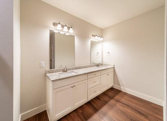 A bathroom with a vanity and a mirror.