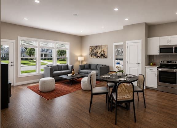 A modern kitchen with a dining table set for four.