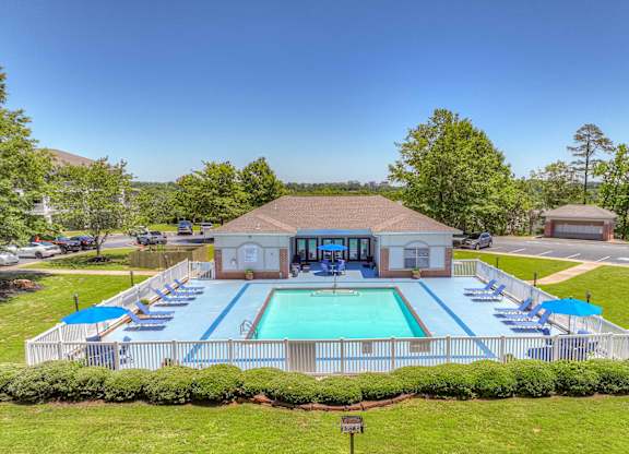 A pool with a building behind it.