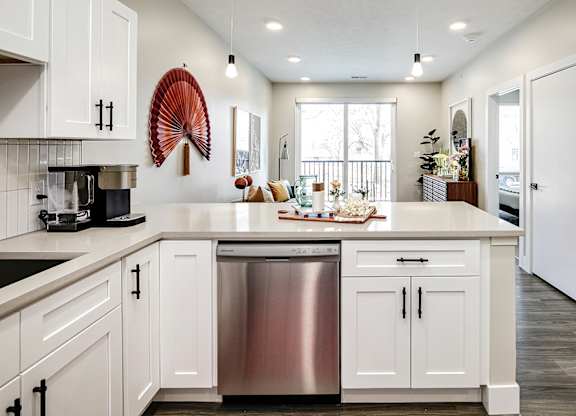 Brand new modern studio, one and two-bedroom apartment homes featuring stainless steel appliances, tile backsplash, quartz countertops, LVP flooring, large picture windows, in-unit washer and dryer and balconies at The Artisan at 39th in Omaha, NE