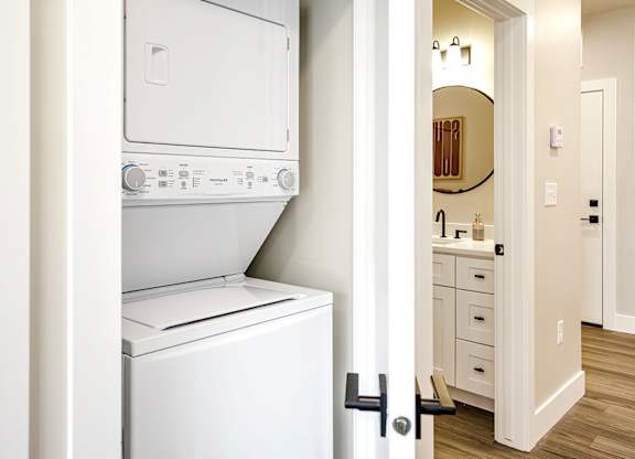 Brand new modern studio, one and two-bedroom apartment homes featuring stainless steel appliances, tile backsplash, quartz countertops, LVP flooring, large picture windows, in-unit washer and dryer and balconies at The Artisan at 39th in Omaha, NE