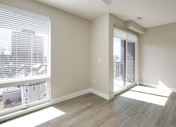 Brand new modern studio, one and two-bedroom apartment homes featuring stainless steel appliances, tile backsplash, quartz countertops, LVP flooring, large picture windows, in-unit washer and dryer and balconies at The Artisan at 39th in Omaha, NE