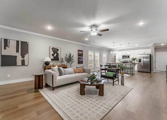 A modern living room with a white couch and a coffee table.