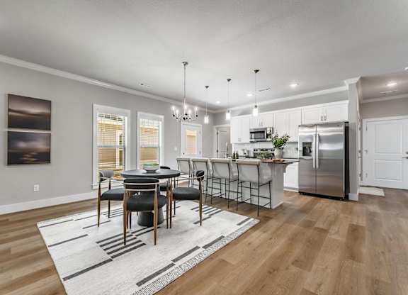A modern kitchen with a dining table set up.