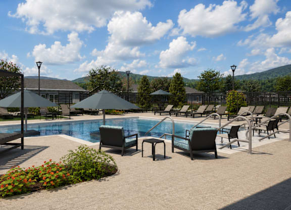 A pool area with sun loungers and umbrellas.