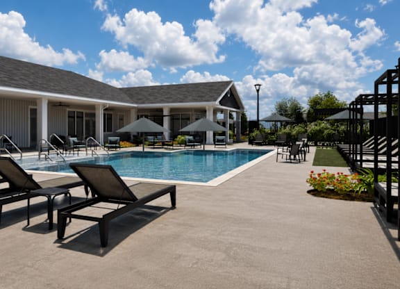 A poolside area with lounge chairs and a building in the background.