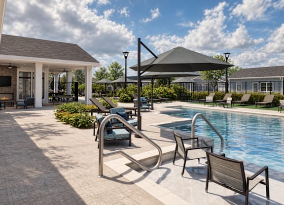 A poolside area with a hot tub and lounge chairs.