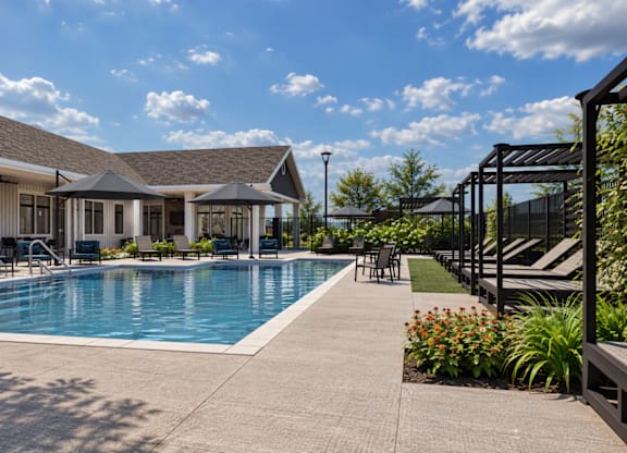 A pool area with a building in the background.