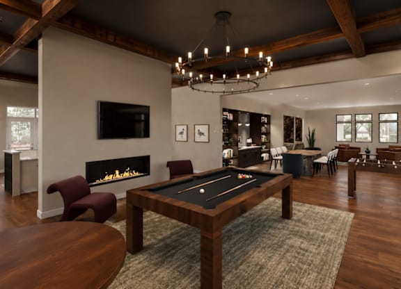 A large room with a pool table and a fireplace.