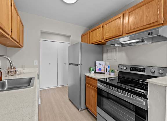 A kitchen with wooden cabinets and stainless steel appliances.