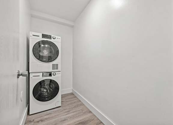 A white washing machine and dryer in a small laundry room.