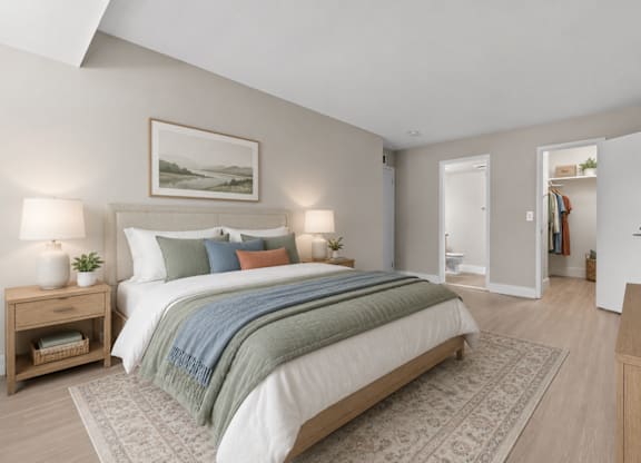 A bedroom with a large bed and a painting above it.