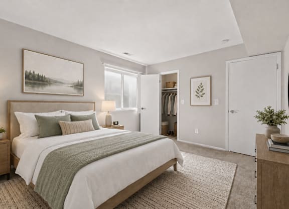 A bedroom with a large bed and a painting on the wall.