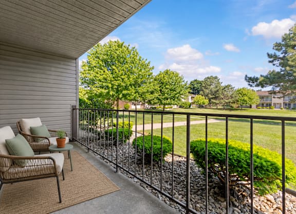 A patio with a chair and table is shown.