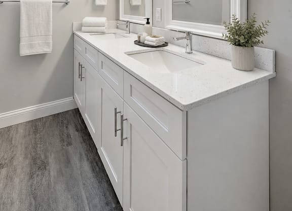 A bathroom with a large mirror and a window with a view of a snowy mountain.
