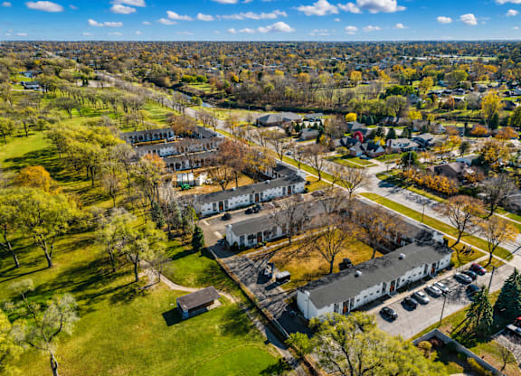 A bird's eye view of a residential area with houses and trees.