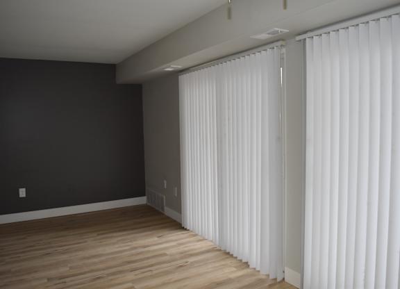 A room with a dark wall and a white curtain at Sunnymede Apartments in Troy, MI