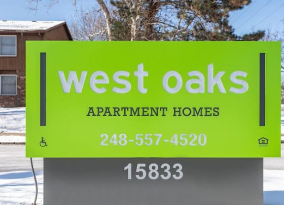 a sign for west oaks apartment homes