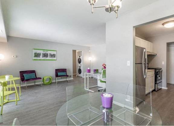 a living room with a glass table and chairs