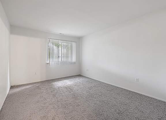 an empty room with a window and white walls at Sunnymede Apartments - Troy, MI, Troy