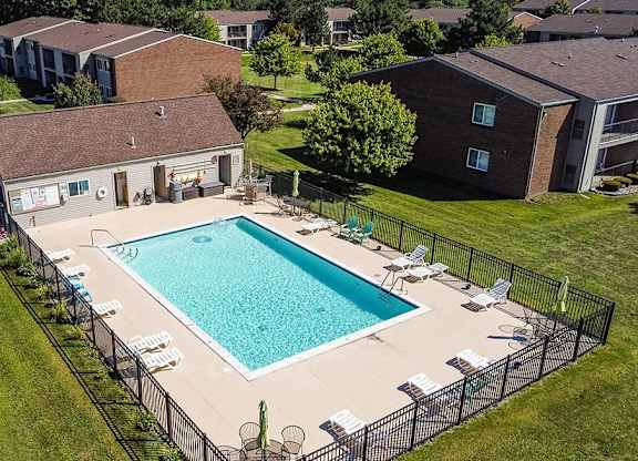 an aerial view of a swimming pool in front of a house at Sunnymede Apartments - Troy, MI, Michigan