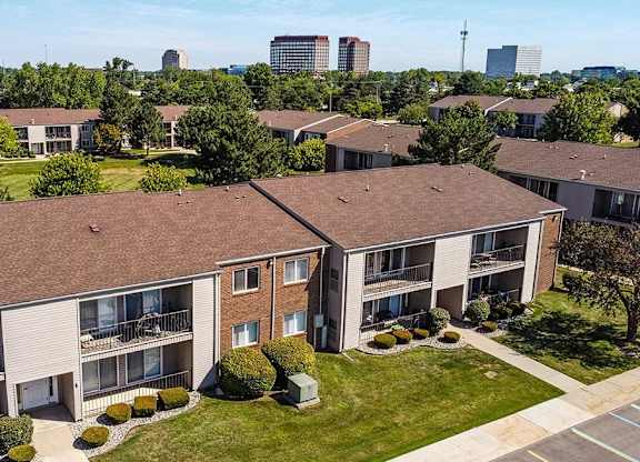 an aerial view of an apartment building with grass and trees at Sunnymede Apartments - Troy, MI, Troy, Michigan