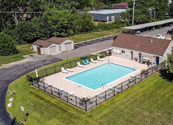a swimming pool in the backyard of a house at Sunnymede Apartments - Troy, MI, Troy, 48084