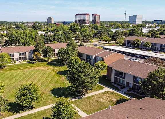 an aerial view of a neighborhood with houses and a field at Sunnymede Apartments - Troy, MI, Michigan