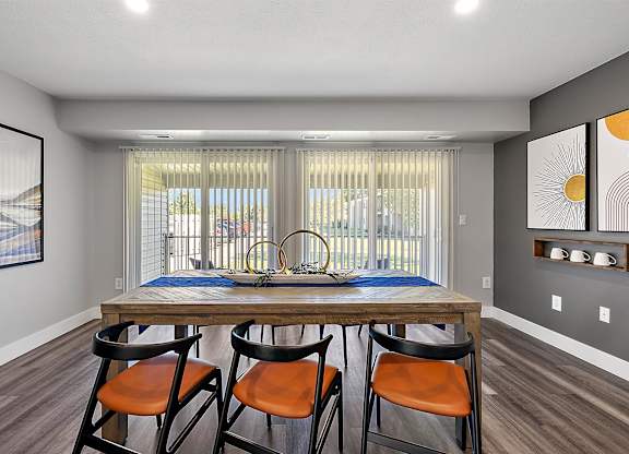 a dining room with a wooden table and four chairs at Sunnymede Apartments - Troy, MI, Troy, Michigan