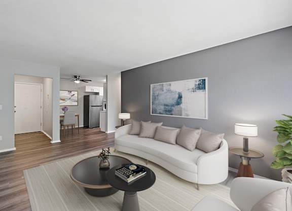 Living with a white couch and a coffee table at Town & Country Apartments - Wixom, MI, Michigan