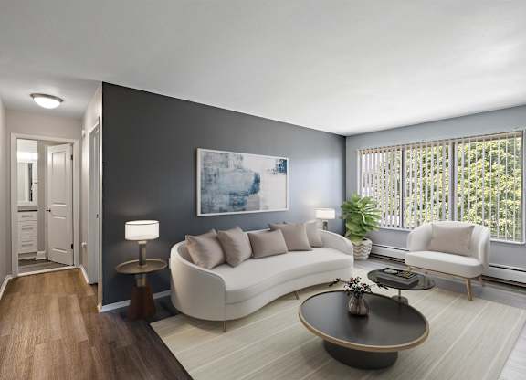 a living room with a white couch and a table at Town & Country Apartments - Wixom, MI, Wixom, Michigan