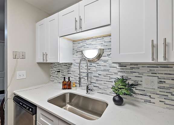 Kitchen with cabinets at Town & Country Apartments - Wixom, MI, Wixom, 48393
