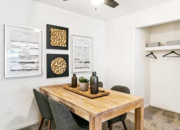 A dining room with a wooden table and chairs at The Waverly on the Lake - Belleville, MI Apartment , Michigan